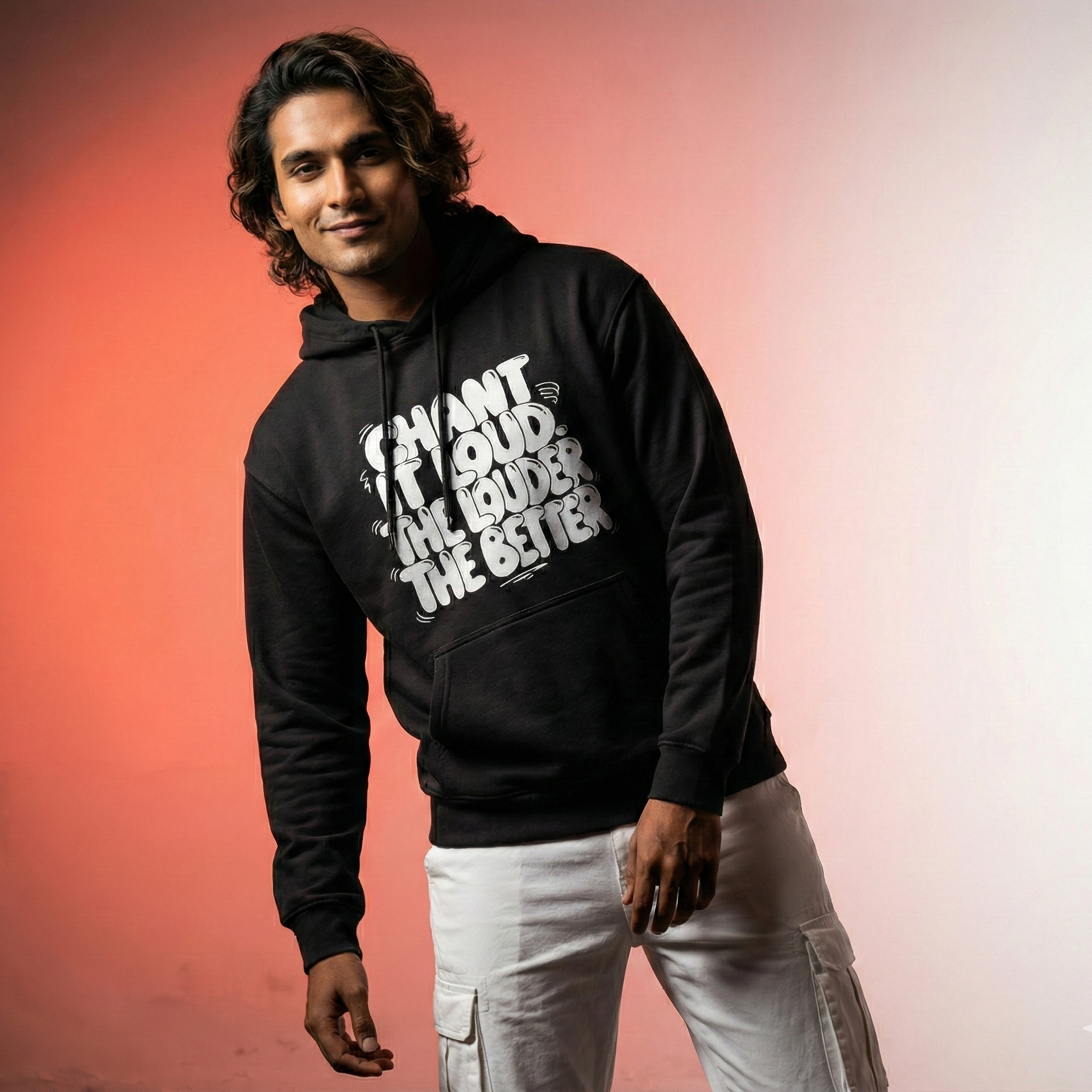 Man wearing a black hoodie with text on a gradient background