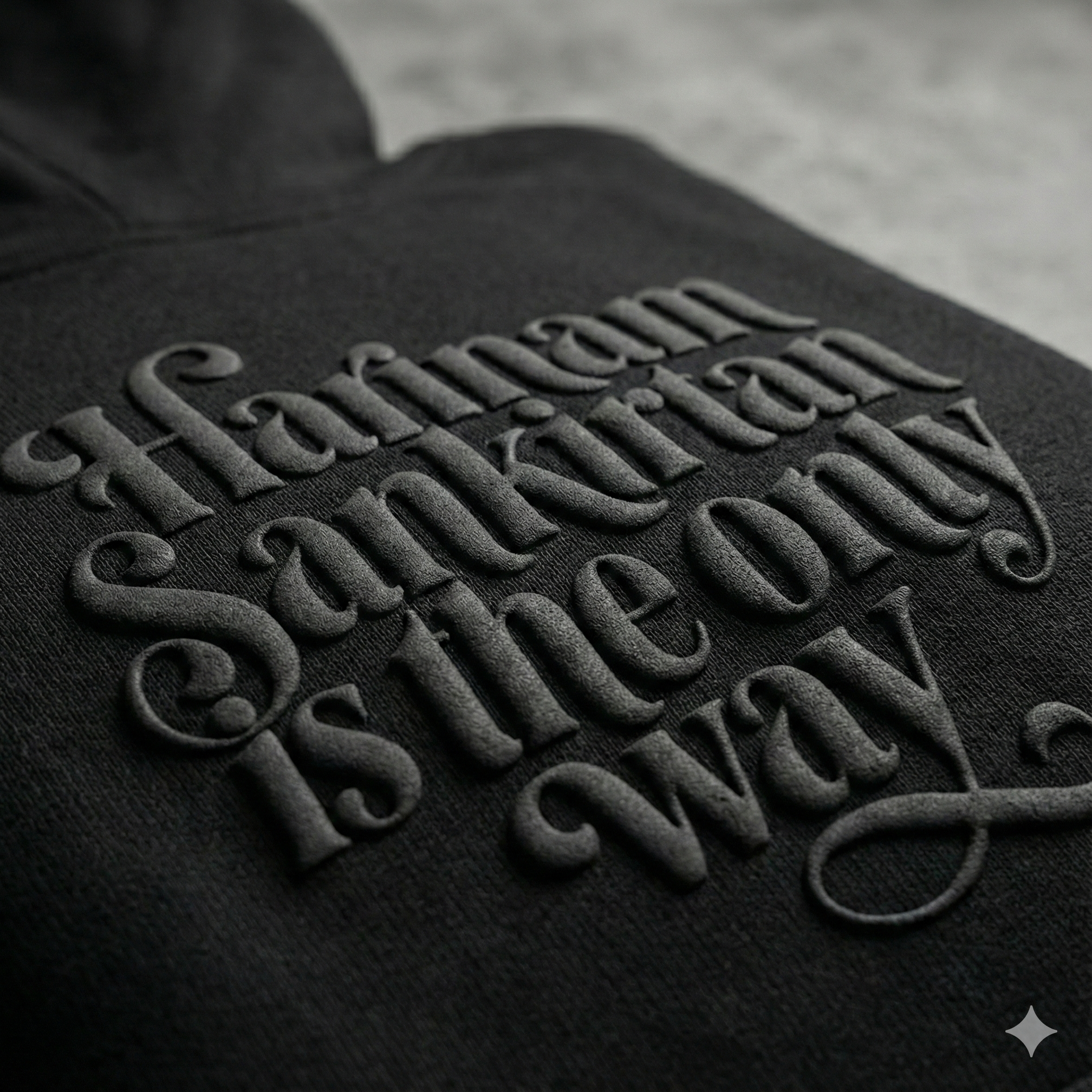 Black hoodie with embossed text on a gray background