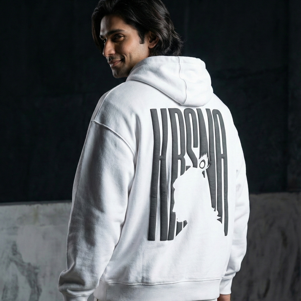Person wearing a white hoodie with text on the back against a dark background