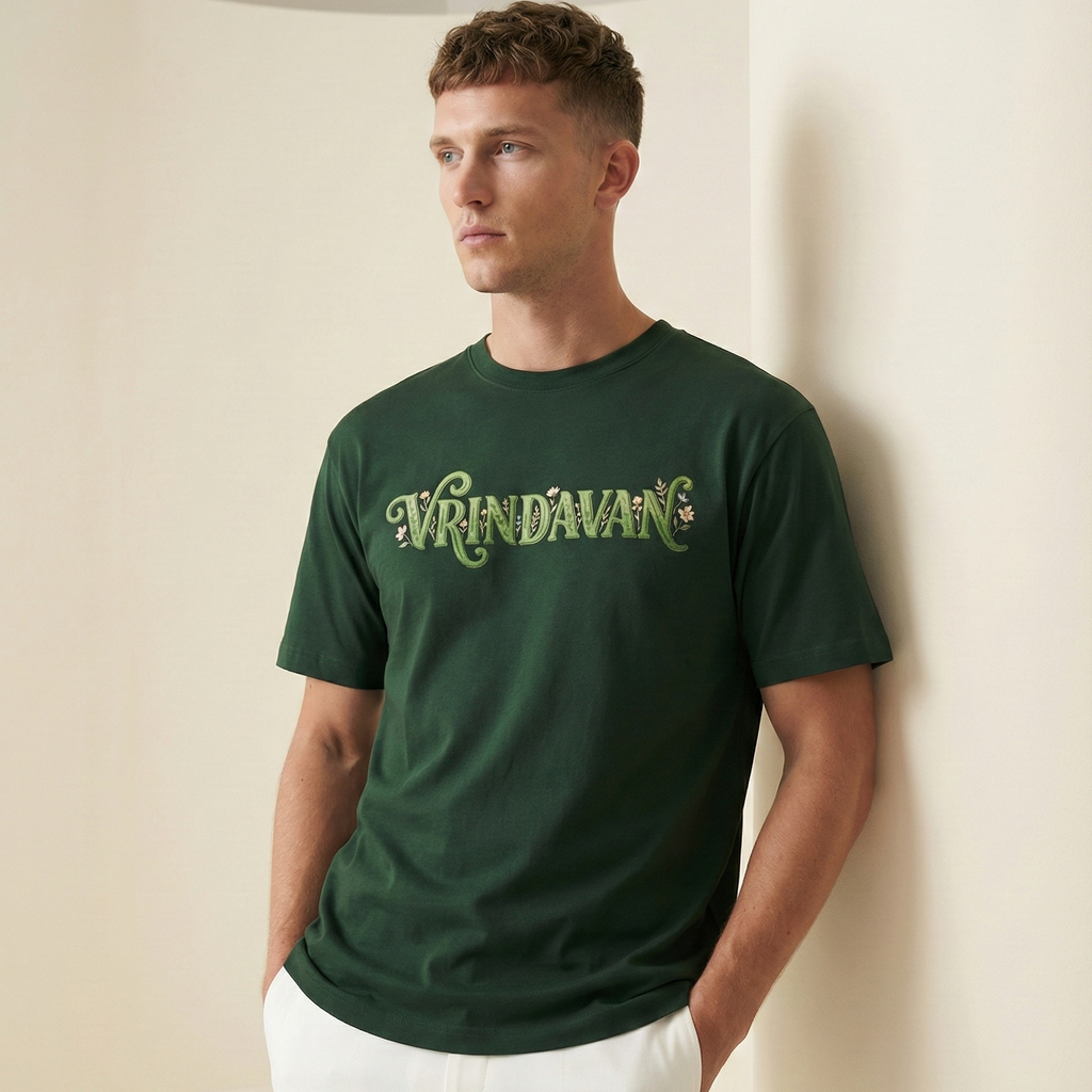 Man wearing a green t-shirt with 'Vrindavan' text against a plain background