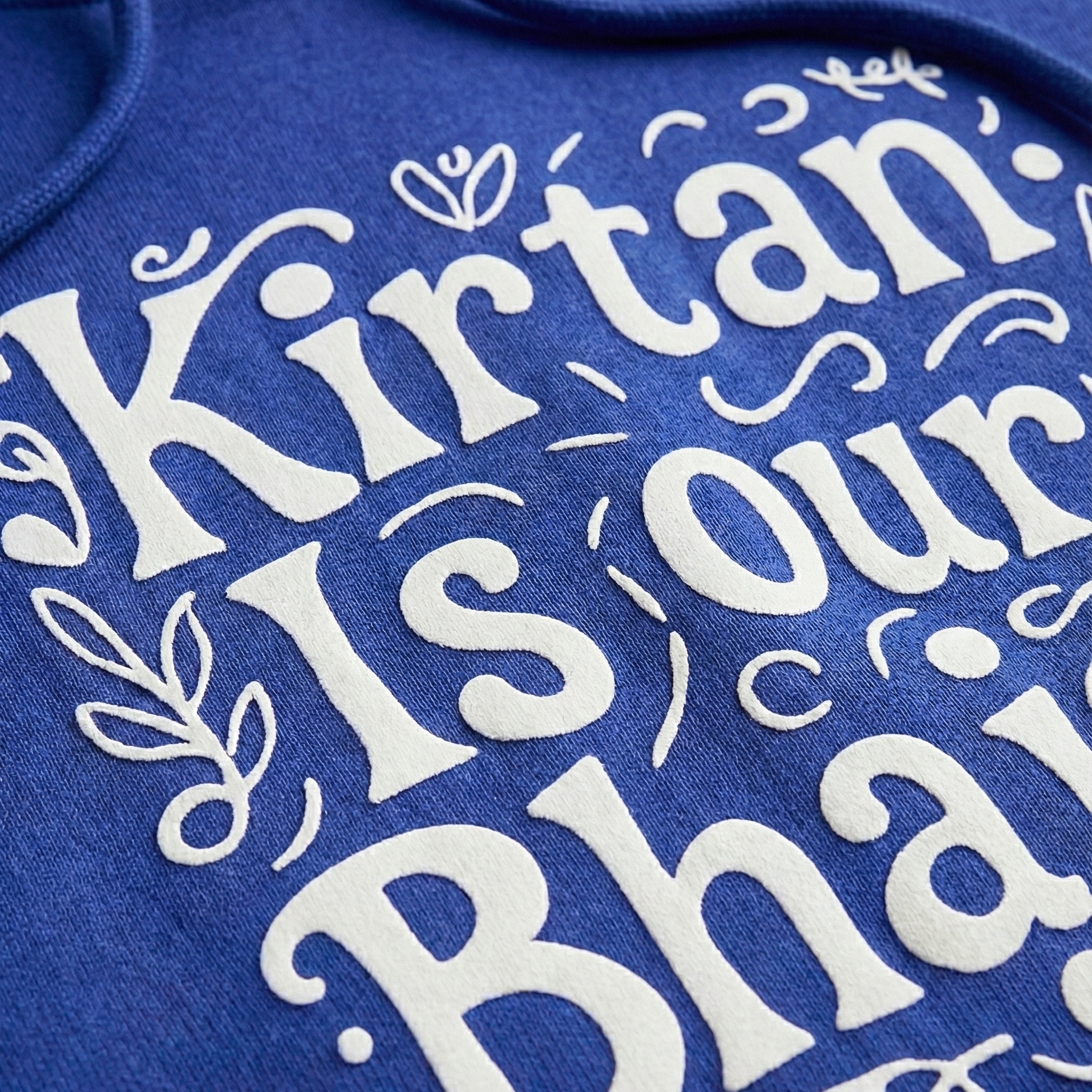 Blue fabric with white embroidered text on a blue background