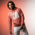 Person wearing a pink hoodie with text on a gradient background