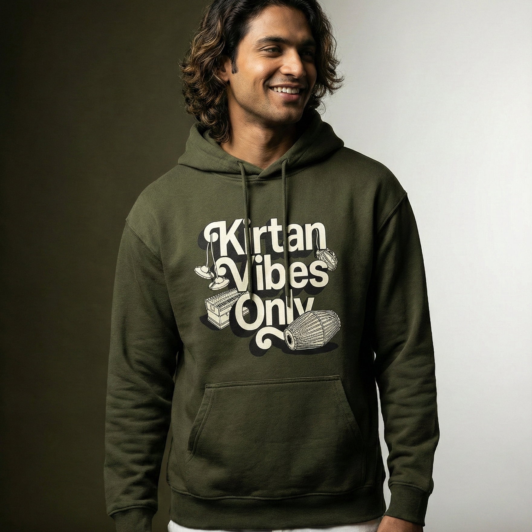 Man wearing a green hoodie with 'Kirtan Vibes Only' text against a gradient background