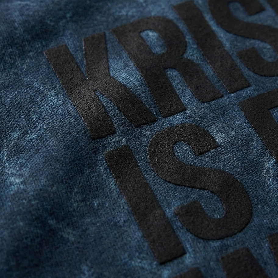 Close-up of a textured blue fabric with embossed text.